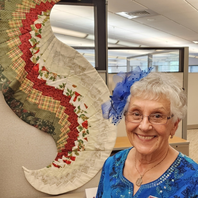 Elaine Baum smiles with her creation, 