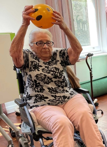 Resident-in-wheelchair-with-exercise-ball.jpg