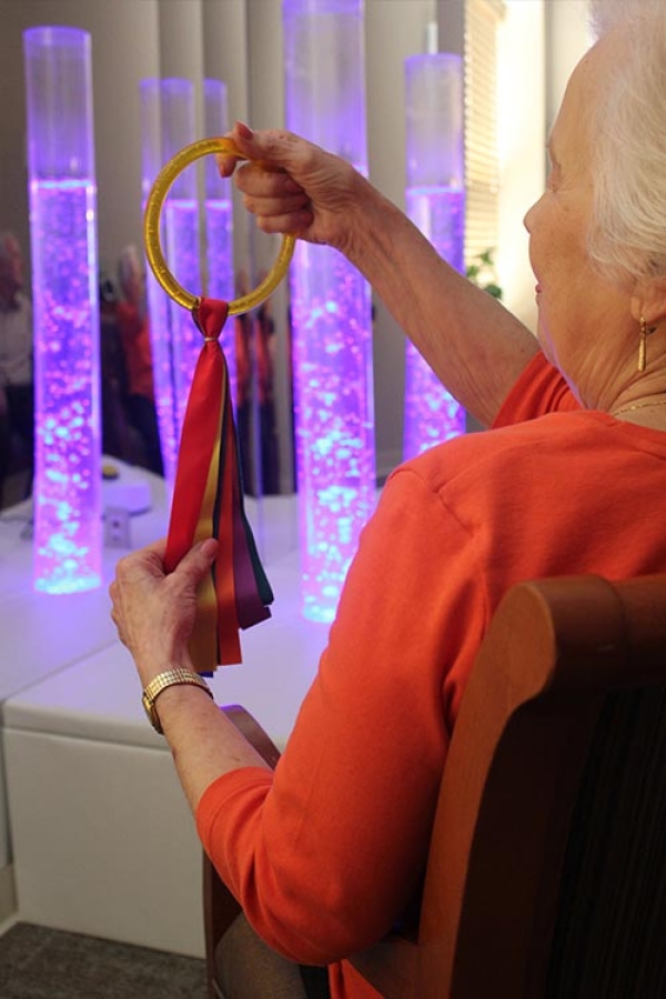 resident holding memory scarf during therapy